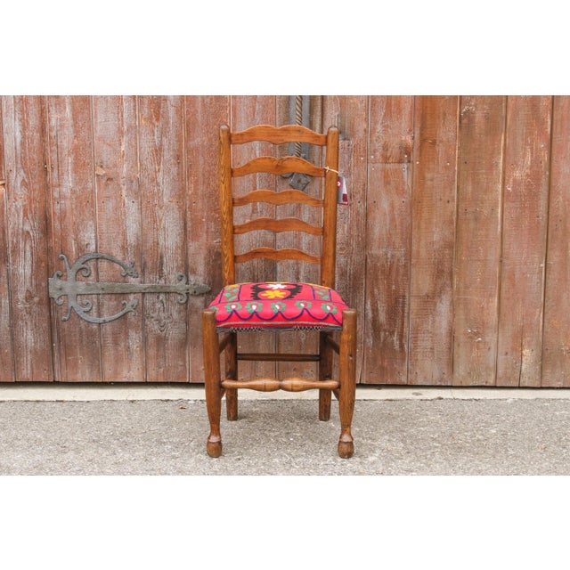 This country style 19th Century ladderback side chair has been reupholstered in a beautiful antique suzani throw. Seat:...