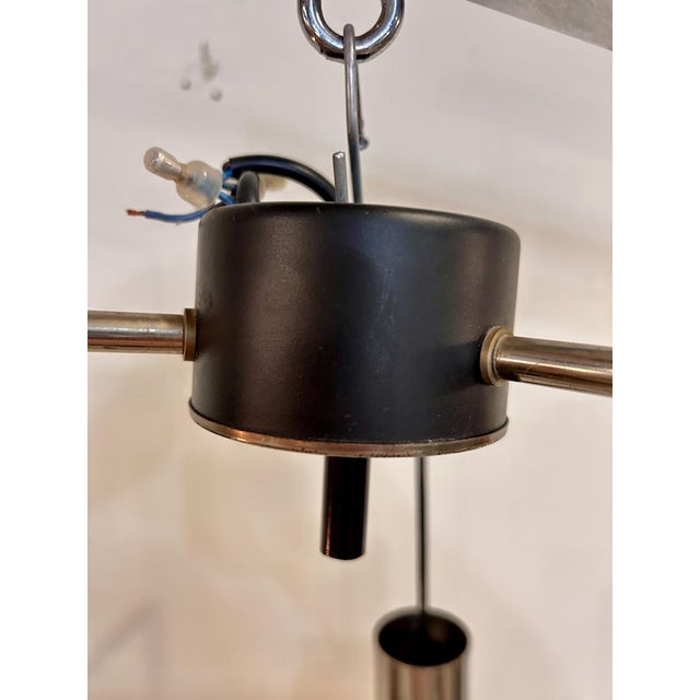 Vintage pendant light from the 1970s composed of three textured acrylic glass diffusers, suspended at different heights on...