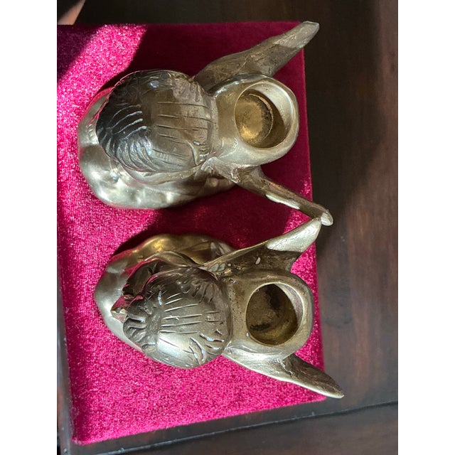 A charming pair of vintage brass cherub candleholders featuring kneeling winged angels rendered in a sweet, devotional...