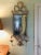 Stylish white painted tole and mirrored two-light sconce and candleholder. White paint with gold paint details. Probably...