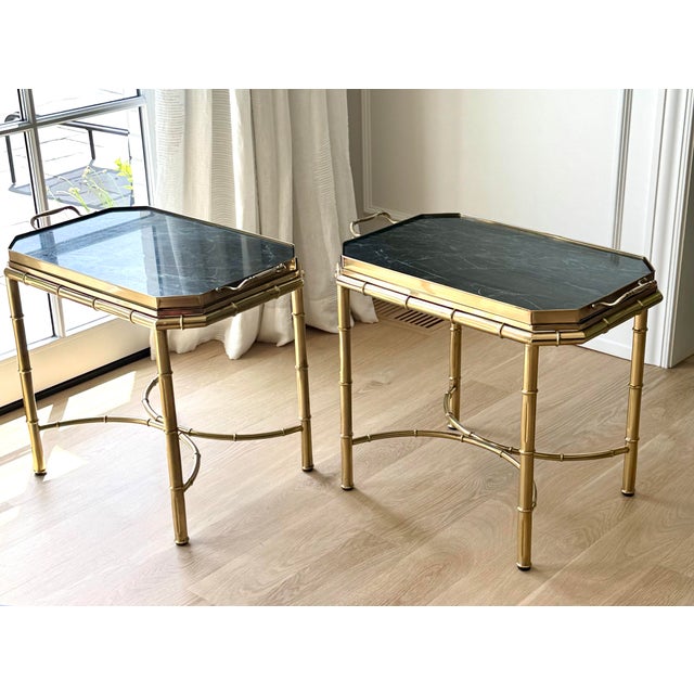 A sophisticated pair of vintage Italian tray tables featuring substantial verde marble trays set within elegant faux...