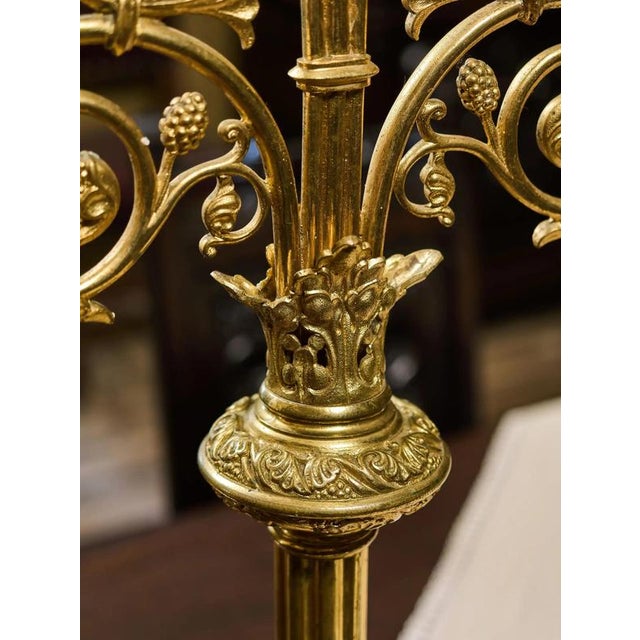Representative pair of candlesticks in neo-Gothic style, made of brass with rich decorative decoration. Both candlesticks...