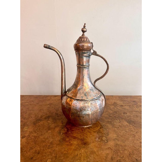 Quality 19th Century antique Middle Eastern copper coffee pot, having a quality 19th century copper coffee pot with a...
