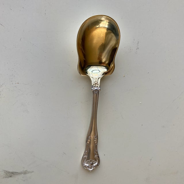 Antique ornait silver plated with gold finish shovel sugar spoon 5.75"L , Makers mark reads " Gorham Hallmark Anchor...