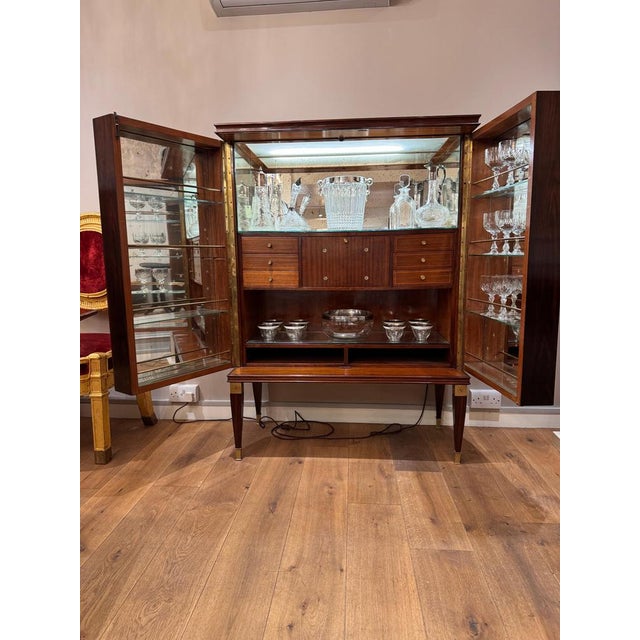 A 1950s Italian mahogany newly restored freestanding bar cabinet by Paolo Buffa . Opposing doors revealing a lit interior...