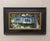This artwork captures a serene cottage nestled within a lush, green landscape, emphasizing the interplay of light and...