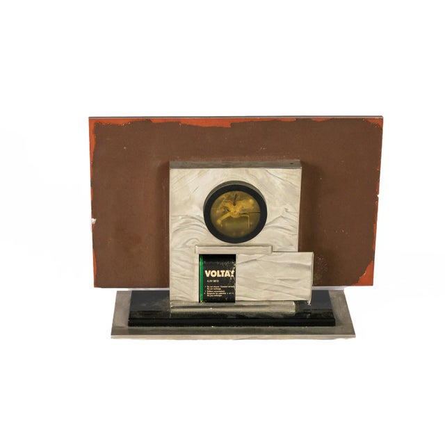 A rectangular Art Deco desk clock with some damage in the front, as visible in the photos, old baterr mechanism as seen in...