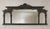 A dramatic vintage architectural wall mirror featuring an ornate dark bronze-tone frame with classical columns, arched...