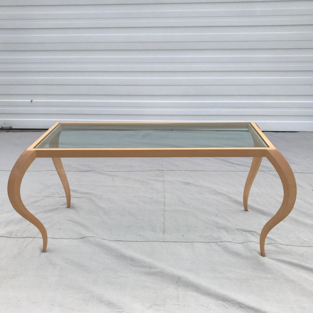 This large, show-stopping table features seductive, sculptural lines and a heavy, removable 1/2 inch glass top that rests...