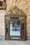 Rectangular mirror with ebonized wood frame, adorned with repoussé and gilded metal plaques decorated with scrolls,...