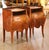 Crafted in France circa 1920, this elegant pair of antique Louis XV-style bedside tables features graceful bombé...