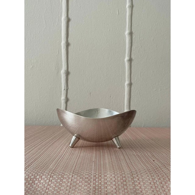 Silver plate bowl made by F.B. Rogers Silver Co. Lifted by a set of cute module feet, iconic midcentury modern. This bowl...