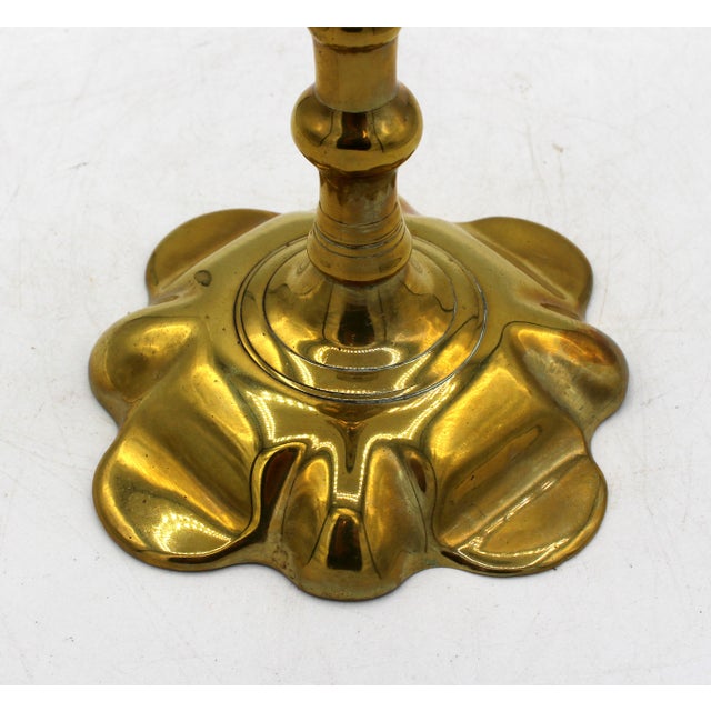 Circa 1730-40 George II period brass candlestick. Petal base with conforming knob & bobeche. Base carefully scraped....