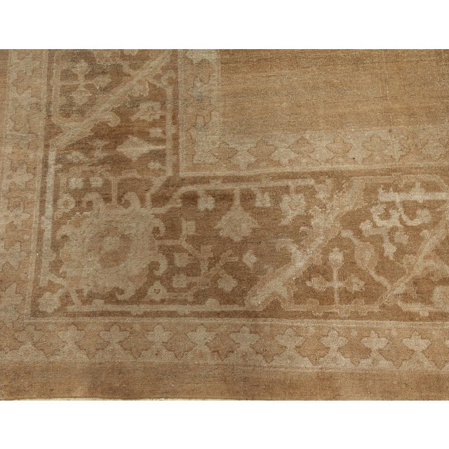 A late 19th century Indian Amritsar antique rug, the striated open cocoa field with four subtle beige floral bouquets...