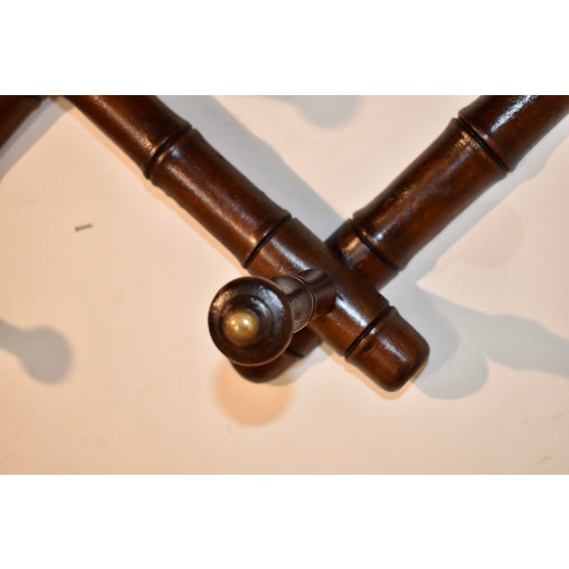 Circa 1900-1909 expandable hat or coat rack from France. The rack is turned from cherry and has three hand turned hat...