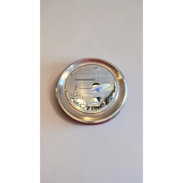 Large round mirror with beveled glass and a nickel-plated brass frame. Made in Italy between the late 1960s and early...