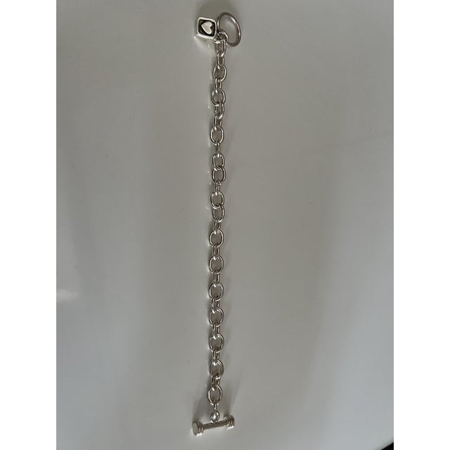 Chunky Sterling Silver Link Bracelet Featuring a Classic Tibetan Toggle Clasp and a Square Heart-Accented Charm For Sale In Los Angeles - Image 6 of 6
