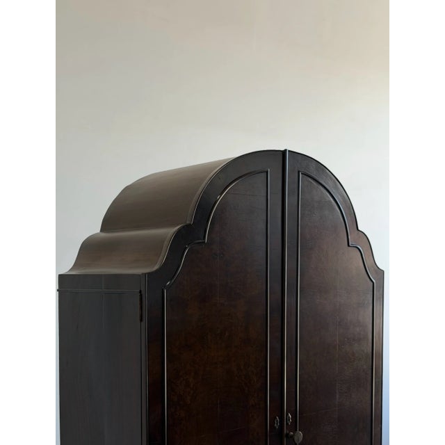 W44 D22.25 H80 This grand Art Deco armoire has been fully refinished to showcase its rich burl walnut grain and elegant...