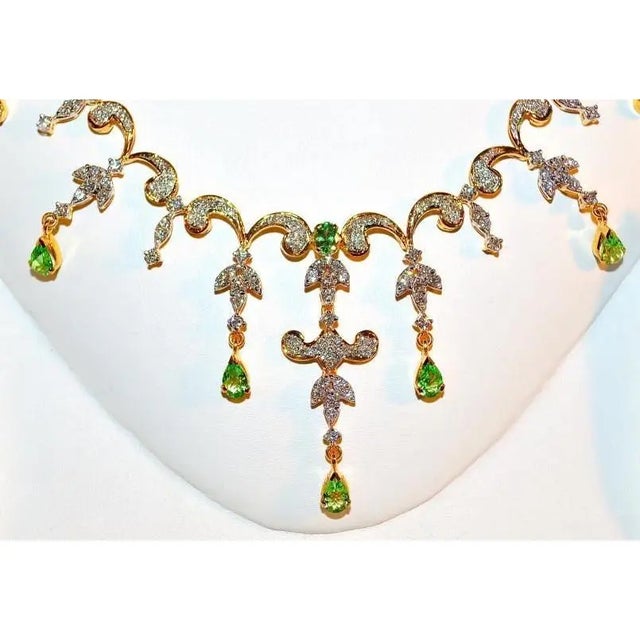 Gorgeous 18K solid gold 11.02CTS diamond and tsavorite garnet necklace earrings set. This set is loaded with 5.73cts of...