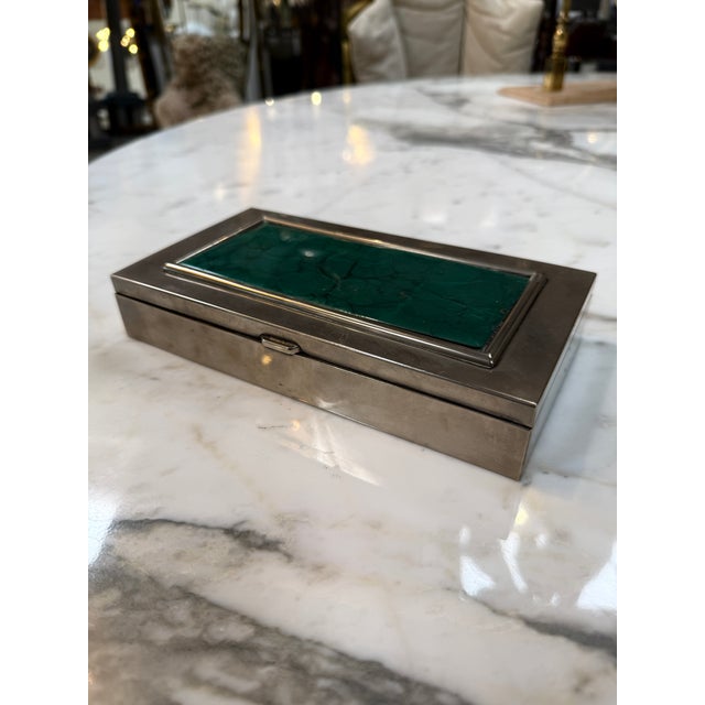 Elegant vintage rectangular box featuring a sleek silverplate exterior accented by a striking malachite inlay lid in rich...