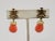 1960s goldtone Asian character tops with faux-coral drops clip earrings. Marked crown "TRIFARI." Measure:1 5/8 inches long...