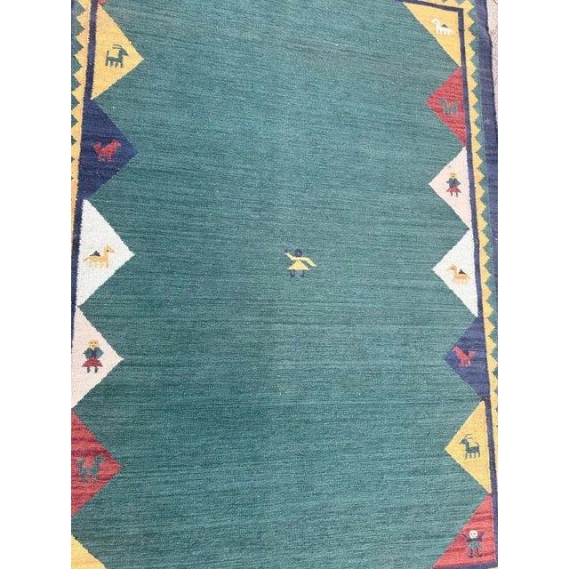 Beautiful vintage Indian Kilim with the design of gabbeh rugs and nice colours with a green field, blue, yellow, red, pink...