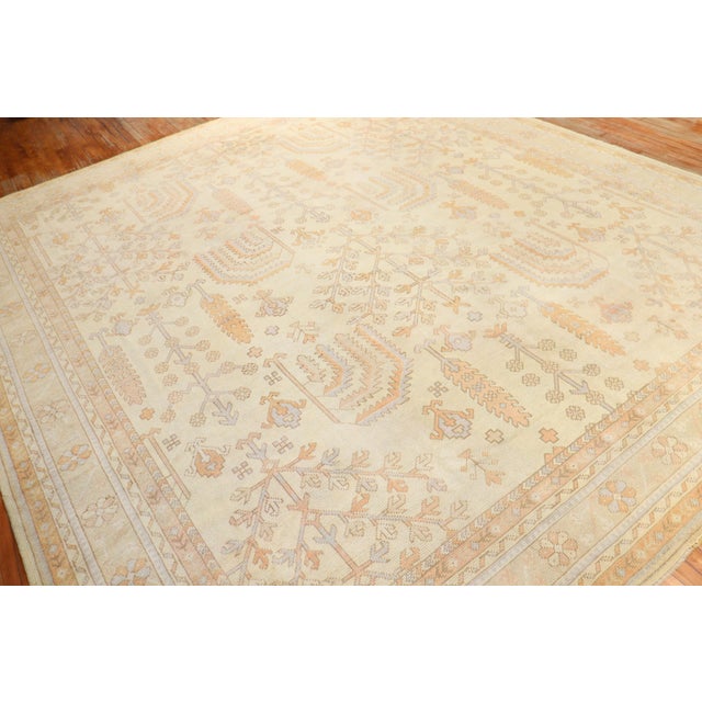 An early 20th-century square room size Turkish Oushak rug with a willow tree motif on an ivory ground Measures: 11'1'' x...