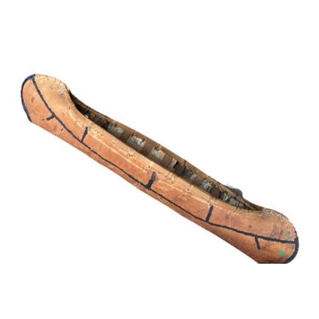 A large 1940 vintage birch bark model canoe — bark in very good condition. Measures 43"L × 9"W × 8.5"H. A striking lodge...