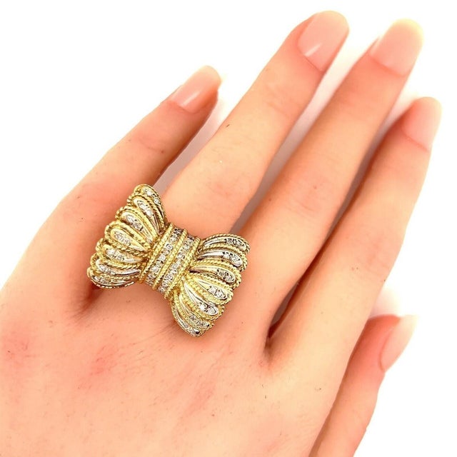 This authentic vintage bow ring is crafted in solid 14k yellow and white gold and features an elaborate frilled bow design...