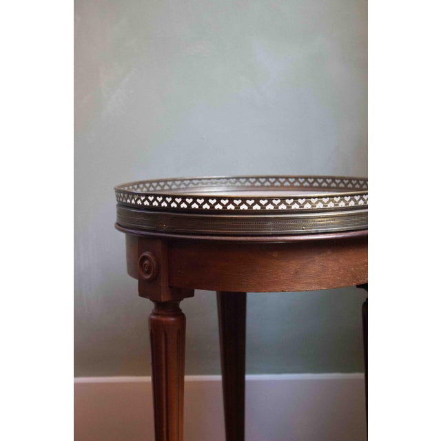 A timeless French accent table featuring a marble top with delicate eyelet detailing around the edge. The perfect piece...