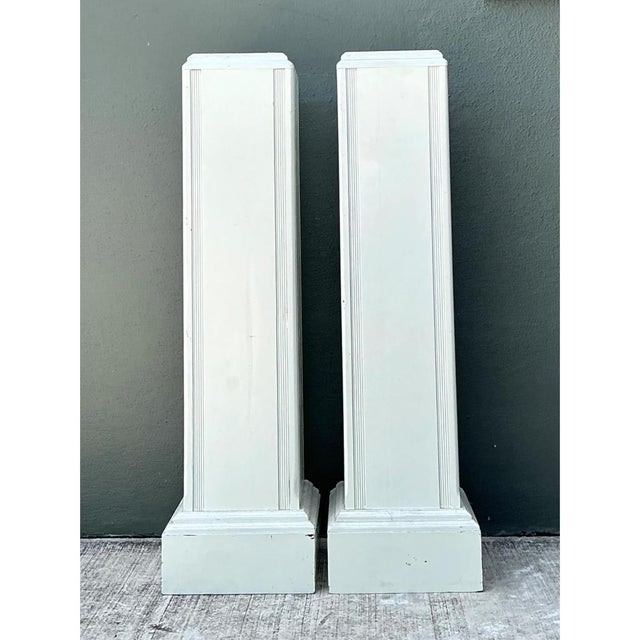 Crafted in a classic architectural column form, this pair of 20th-century wooden pedestals brings dramatic height,...
