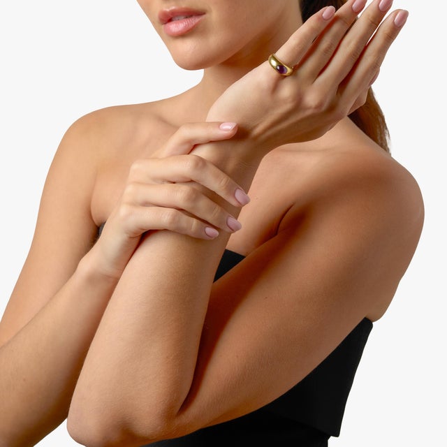 This elegant Tiffany & Co. ring showcases a richly colored cabochon amethyst, glowing with deep purple hues that feel both...