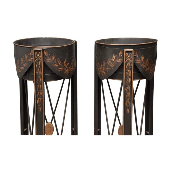 This is a pair of tall cast iron black and gold tole planters by Niermann Weeks. Niermann Weeks was very dedicated to...