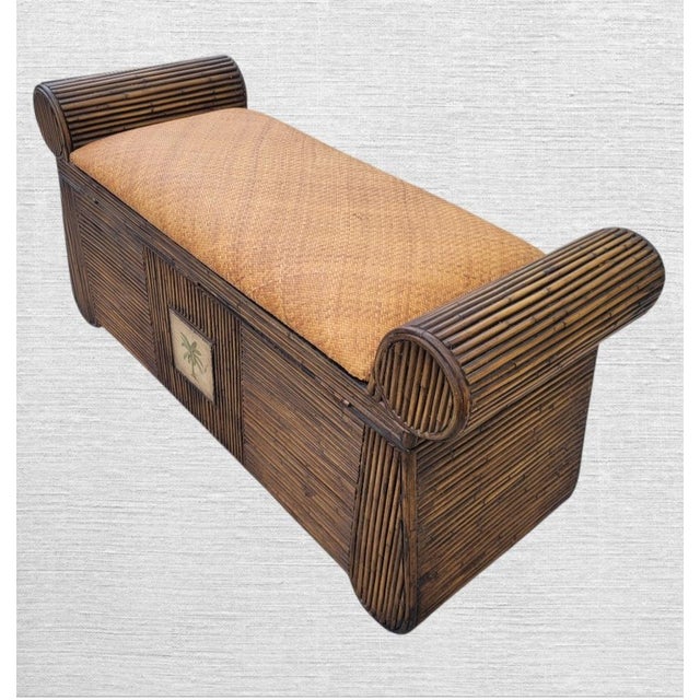A beautiful pencil reed and wicker flip top storage bench. The bench features thick rolled arms with a brown stained...