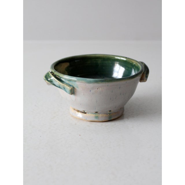 This vintage studio pottery colander features a soft gray exterior paired with a rich green glazed interior. The small...