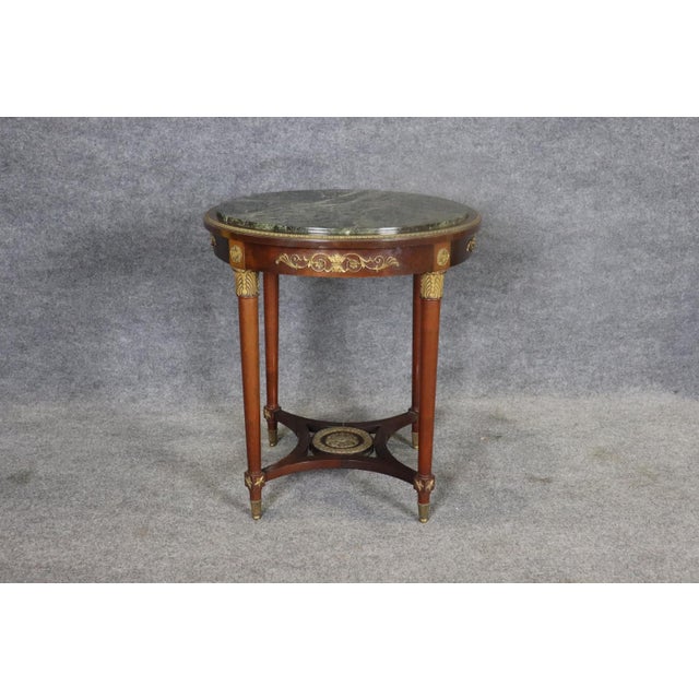 Introduce timeless sophistication to your home with this 19th Century Empire Bronze Mounted Marble Top Round Table, a...