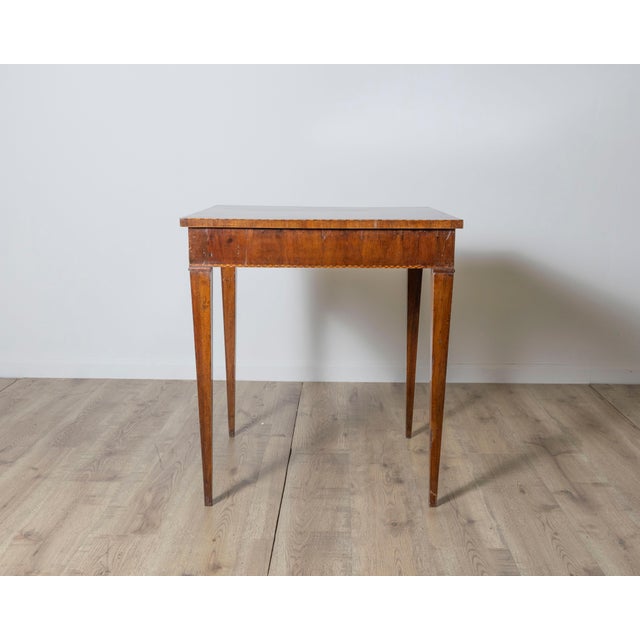 A beautifully preserved Tuscan game table from the 18th century, showcasing the elegance of Italian neoclassical design...