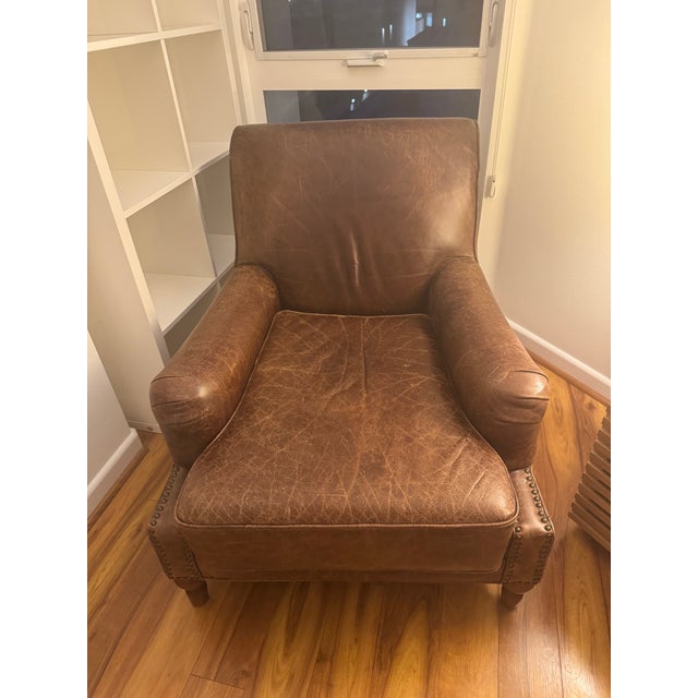 Beautiful oversized genuine leather lounge chair in a warm distressed cognac brown color. Extremely comfortable and deep-...