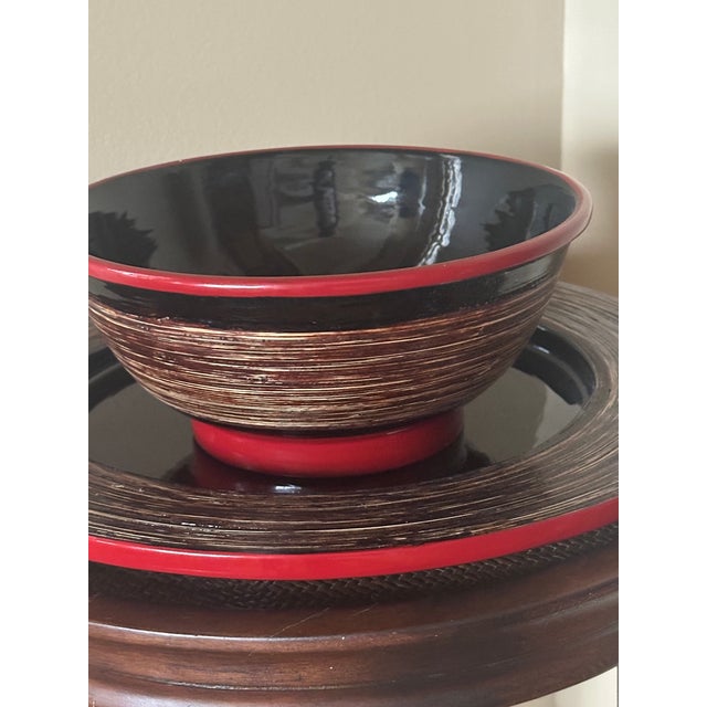 A vibrant red rim and foot play against the exposed natural-color bamboo and black lacquer foundation on the Salad Bowl,...
