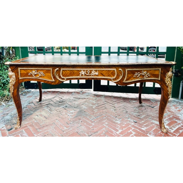 French Louis XV Bureau Plat Desk With Ormolu Mounts, Leather Top & Herringbone Parquetry Veneers A desk so elegant it...