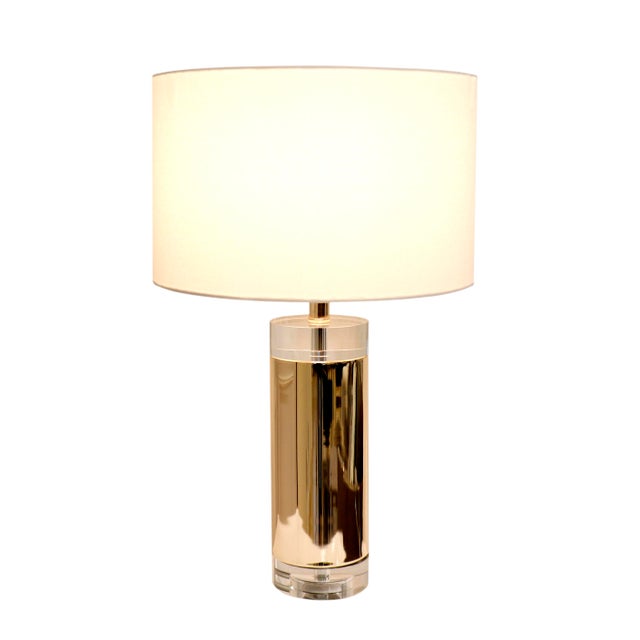 A captivating combination of glass and metal, our grand Jupider lamp consists of a cylindrical glass and gold metal base...