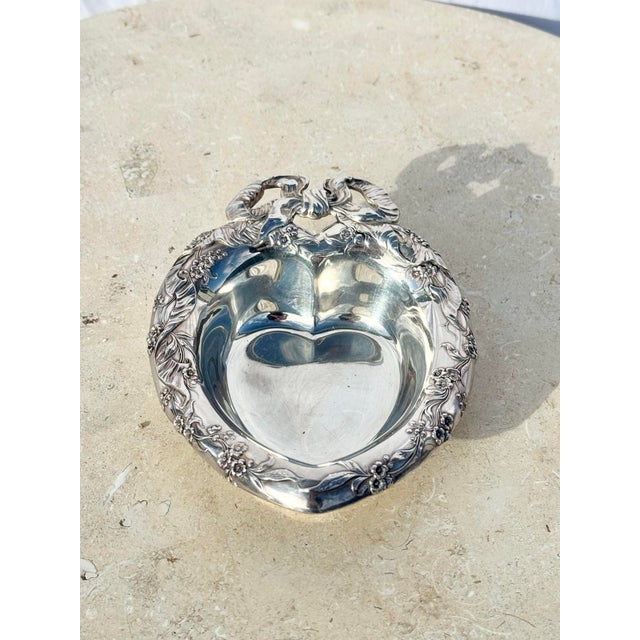 This elegant vintage Reed & Barton 230 silver-plated heart dish is a timeless piece of heirloom-quality craftsmanship,...