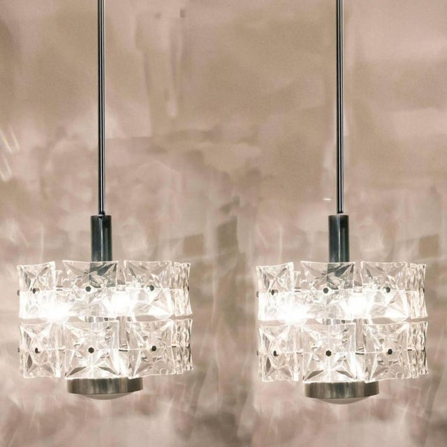 A pair of very modern, elegant and fine kinkeldey chandeliers. Really heavy quality. They are comfortable with all decor...
