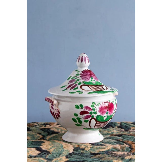 This early 19th-century French faience soup tureen from Les Islettes showcases a refreshing decor in pink & green of a...