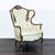 This victorian style lounge chair features a tall, tufted backrest and elegant floral upholstery. The dark wood frame is...