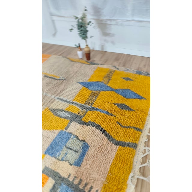 One-of-a-kind handwoven Moroccan Boujaad rug — warm mustard and dove grey, crossed by a chain of navy and slate-blue...