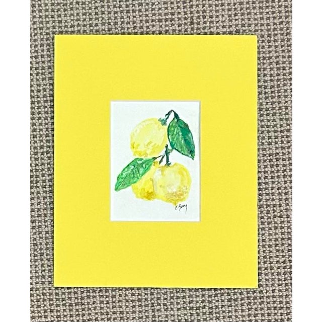 Bright yellow lemons by Elizabeth Berry matted in lemon yellow. A perfect small accent for most any place. Measures: 9W X 11H
