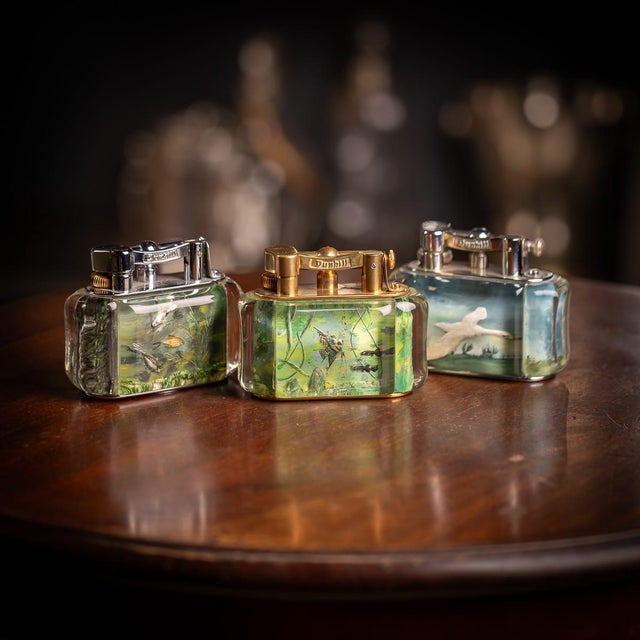 Vintage mid 20th Century Dunhill Aquarium table lighter. Crafted in a curved rectangular shape with silver-plated mounts,...