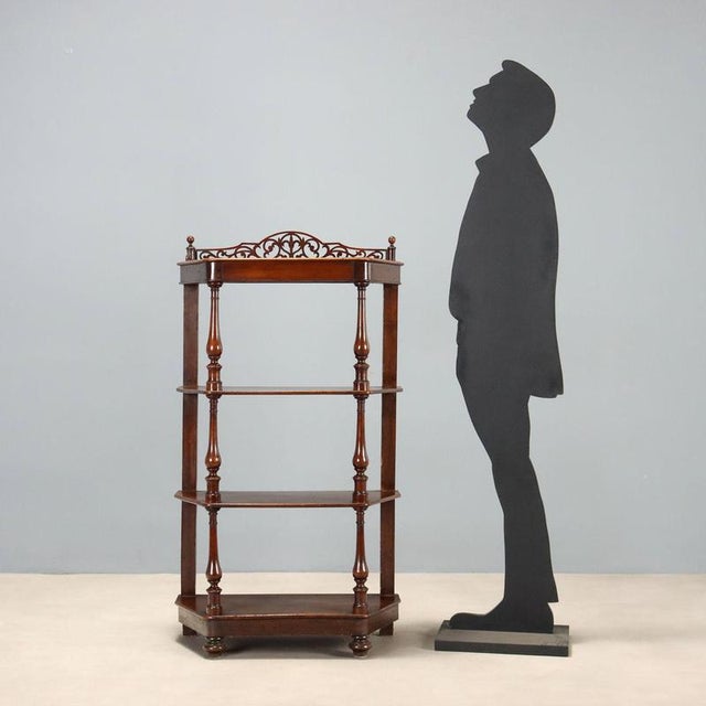 Louis Philippe étagère crafted in walnut, featuring four trapezoidal shelves that offer an elegant functional and...