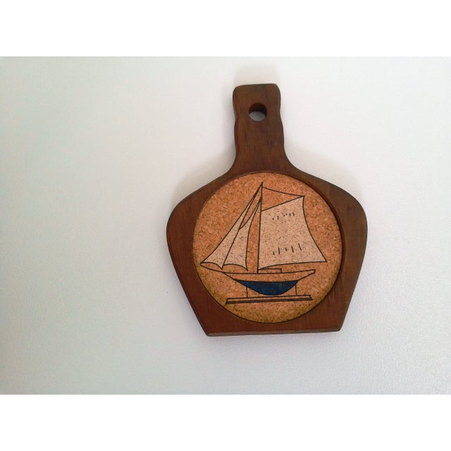 Cool set of eight wood coasters with cork insets depicting a navy blue hull and white sails model ship. Comes with wood...